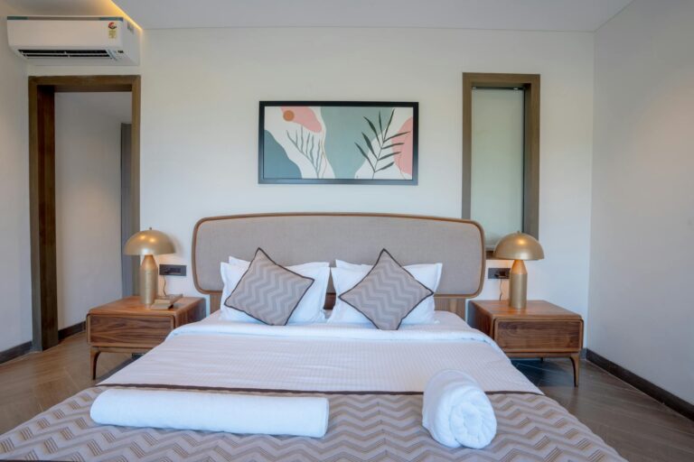 Elegant bedroom with modern decor, showcasing luxury accommodations in Saligao, India.